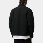 Back view of a person wearing the Carhartt Detroit Jacket spring, showcasing its sturdy design and corduroy collar.